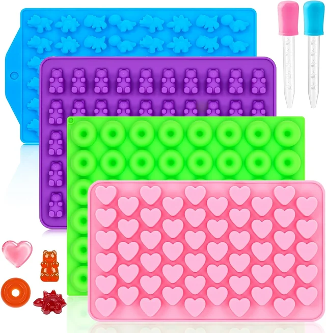 Four colorful candy molds with two droppers